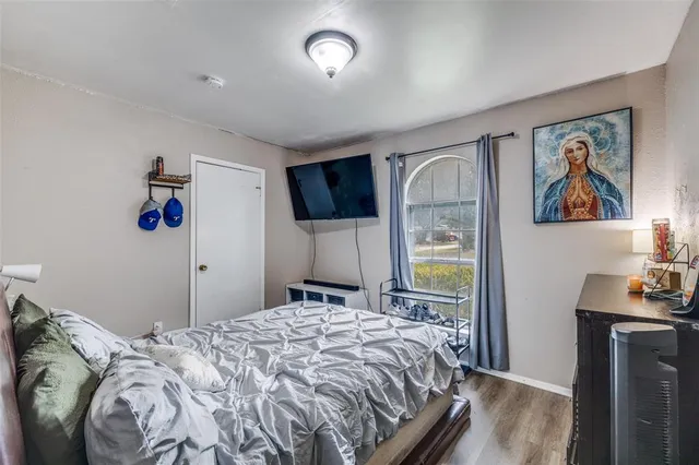 a bedroom with a bed and a flat screen tv