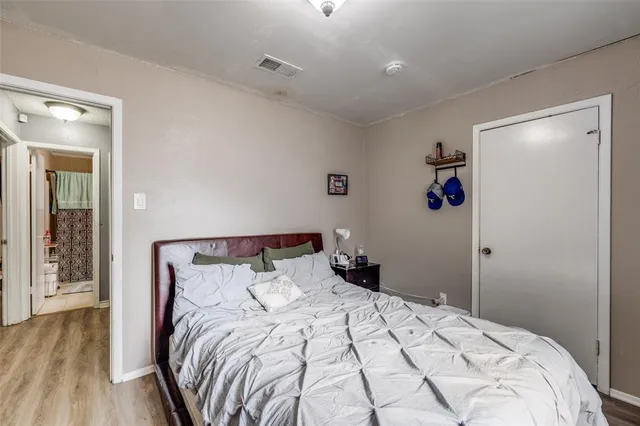 a bedroom with a bed and a mirror