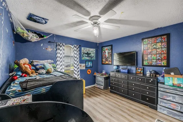 a bedroom with furniture and a flat screen tv