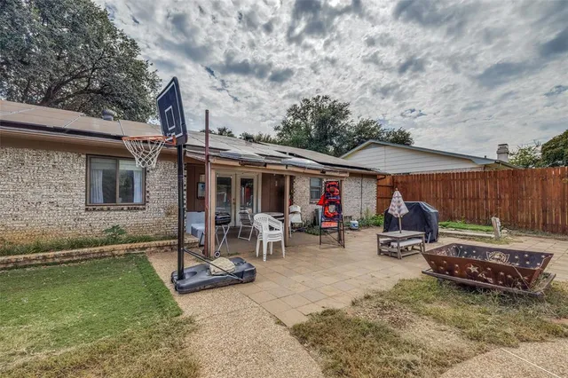 a view of a house with backyard tub and sitting area