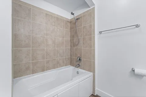 a bathroom with a bathtub and a shower