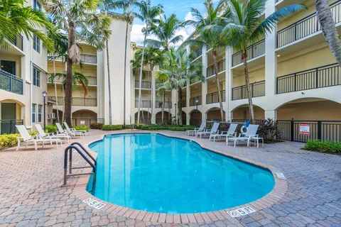 a view of a swimming pool with a lounge chair