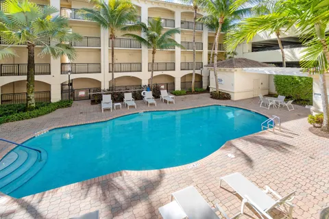 a view of a backyard with swimming pool