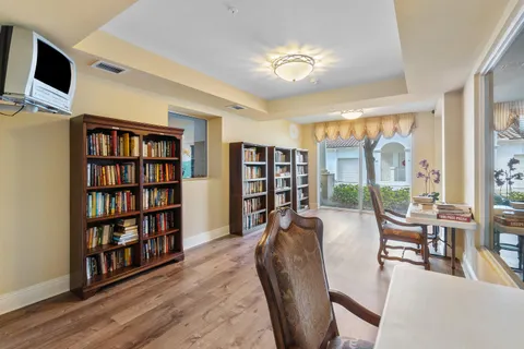 a living room with furniture and a book shelf