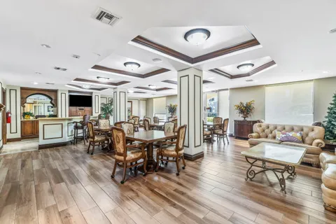 a living room with lots of furniture and a large window