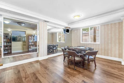 a dining room with furniture and wooden floor