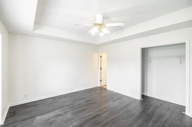 a view of an empty room with wooden floor