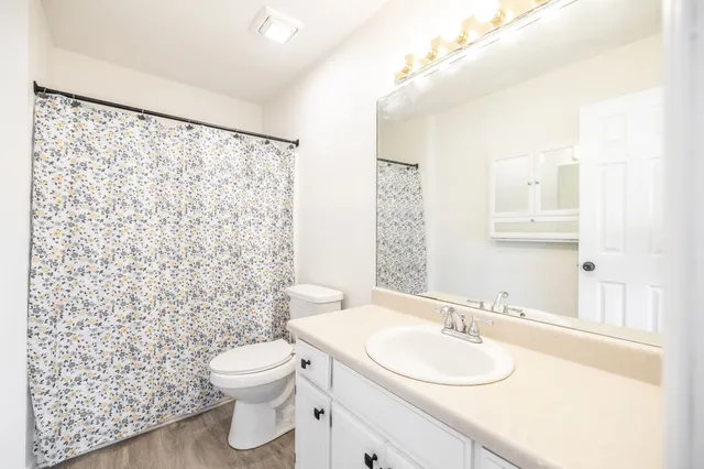 a bathroom with a sink toilet and shower