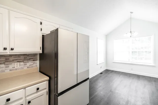 a kitchen with stainless steel appliances a refrigerator and a stove top oven