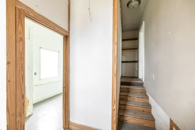 a view of a hallway with wooden floor and entryway