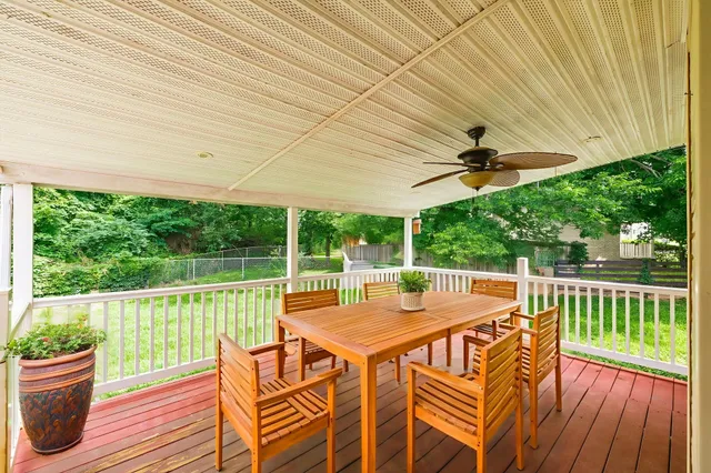 a view of a patio with a table chairs and a backyard