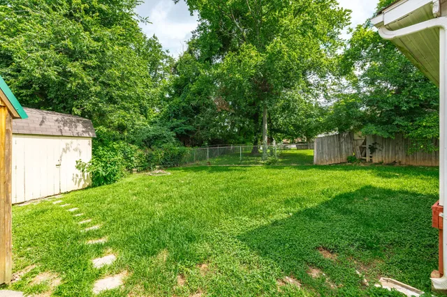 a view of a house with a backyard