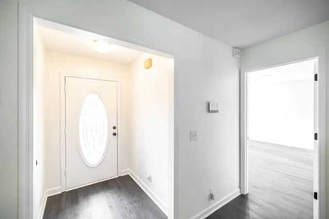 a view of front door with wooden floor