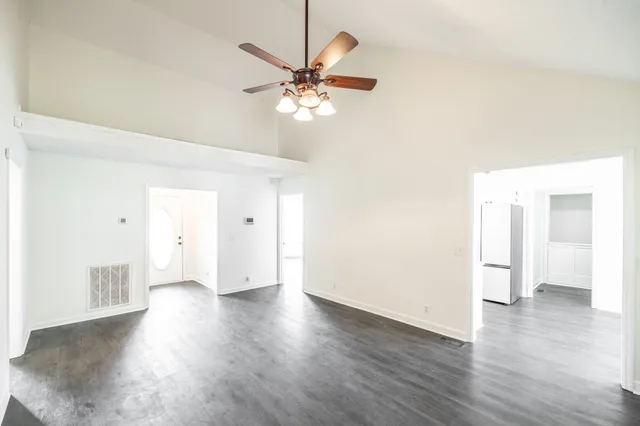 a view of an empty room with wooden floor