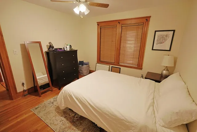 a bedroom with a bed dresser and a window