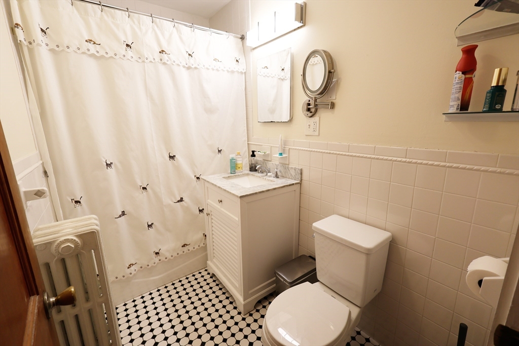 38 Ranelegh Road, Unit 1 Boston, MA 02135 - Photo 12 of 16 a bathroom with a sink toilet and shower