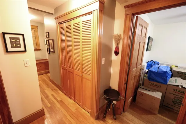 a view of a hallway with furniture and a window