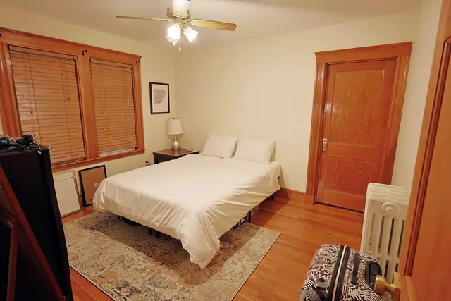 a bedroom with a bed and a mirror