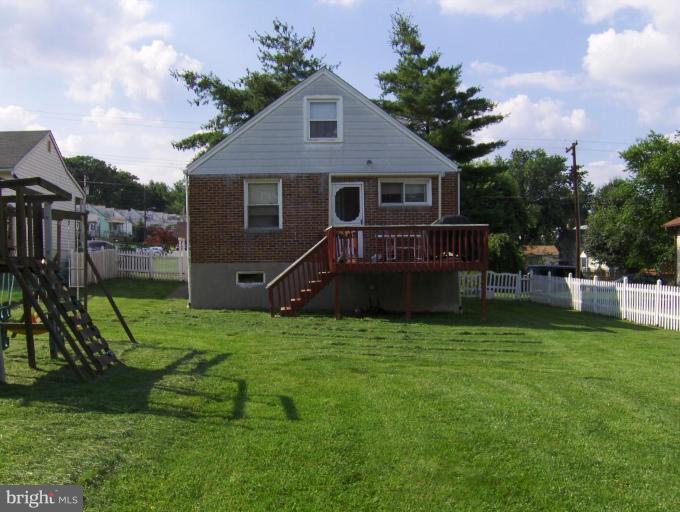 8407 Berkfield Road Rosedale, MD 21237 - Photo 2 of 6 a front view of a house with a yard