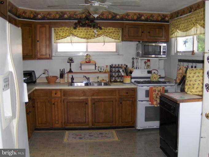 8407 Berkfield Road Rosedale, MD 21237 - Photo 5 of 6 a kitchen with a sink cabinets and window
