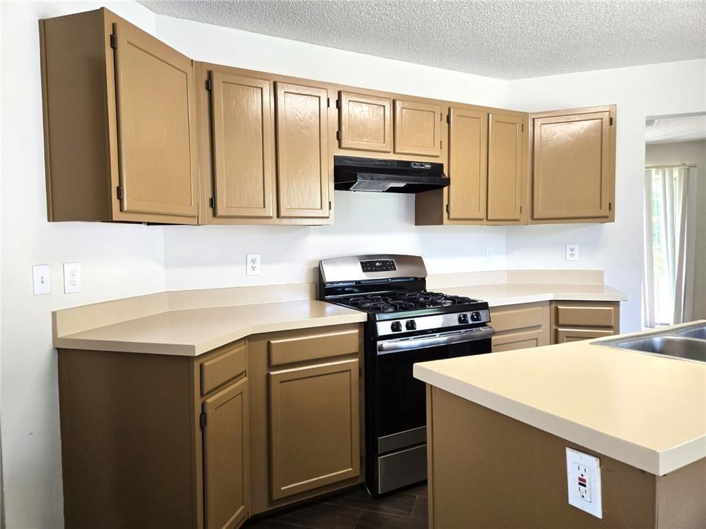 6445 Marsham Drive Atlanta, GA 30349 - Photo 13 of 28 a kitchen with cabinets appliances and a sink