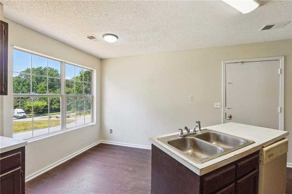 6445 Marsham Drive Atlanta, GA 30349 - Photo 15 of 28 a bathroom with a sink and a window