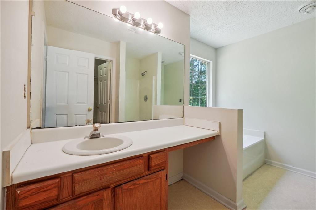 6445 Marsham Drive Atlanta, GA 30349 - Photo 19 of 28 a bathroom with a sink double vanity and a mirror