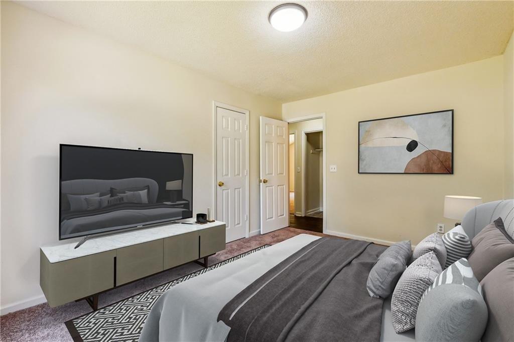6445 Marsham Drive Atlanta, GA 30349 - Photo 24 of 28 a bedroom with a bed and couch