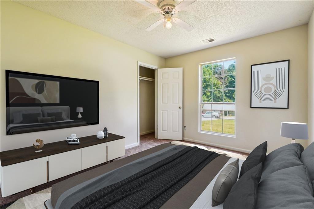 6445 Marsham Drive Atlanta, GA 30349 - Photo 25 of 28 a living room with furniture and a flat screen tv