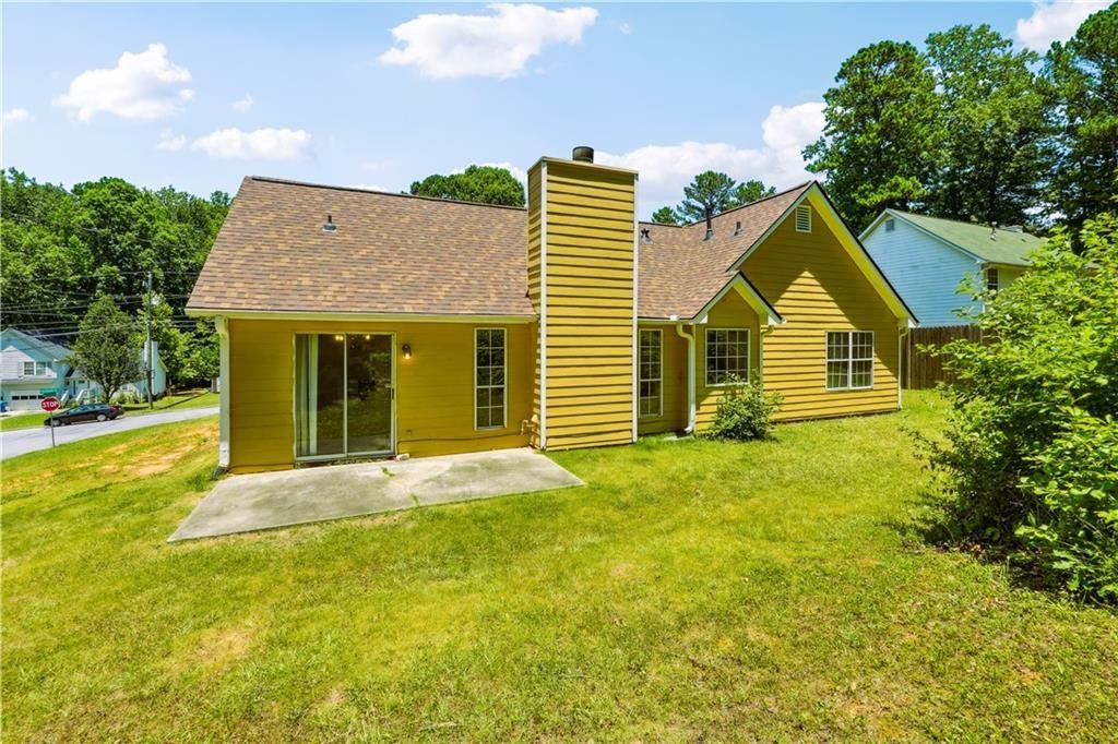 6445 Marsham Drive Atlanta, GA 30349 - Photo 27 of 28 a front view of a house with a garden