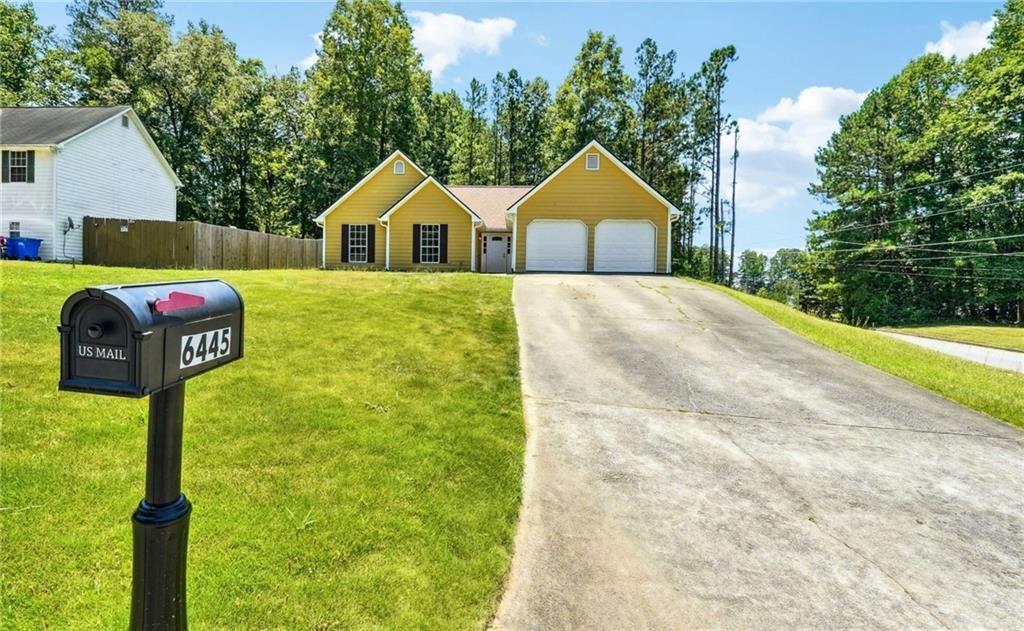 6445 Marsham Drive Atlanta, GA 30349 - Photo 28 of 28 a front view of a house with garden