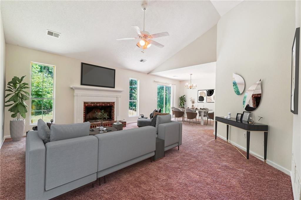 6445 Marsham Drive Atlanta, GA 30349 - Photo 9 of 28 a living room with furniture a fireplace and a flat screen tv