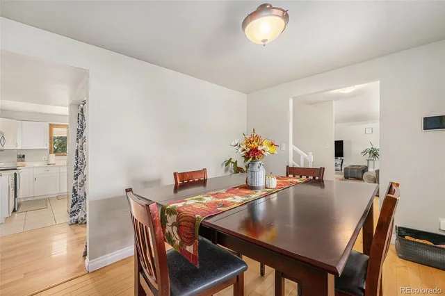 a dining room with furniture and wooden floor