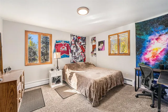 a bed sitting in a bedroom next to a window