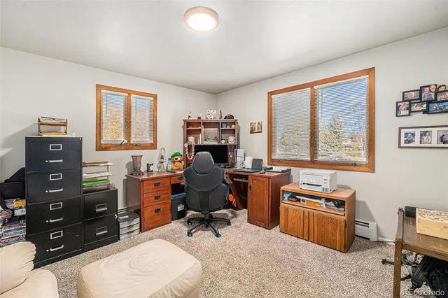 a living room with furniture a lamp and a rug