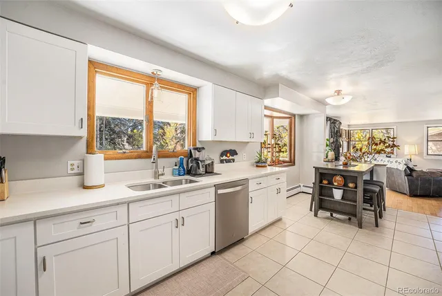 a kitchen with cabinets and chairs