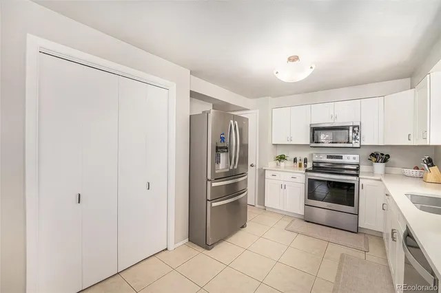 a kitchen with cabinets stainless steel appliances and a counter top space