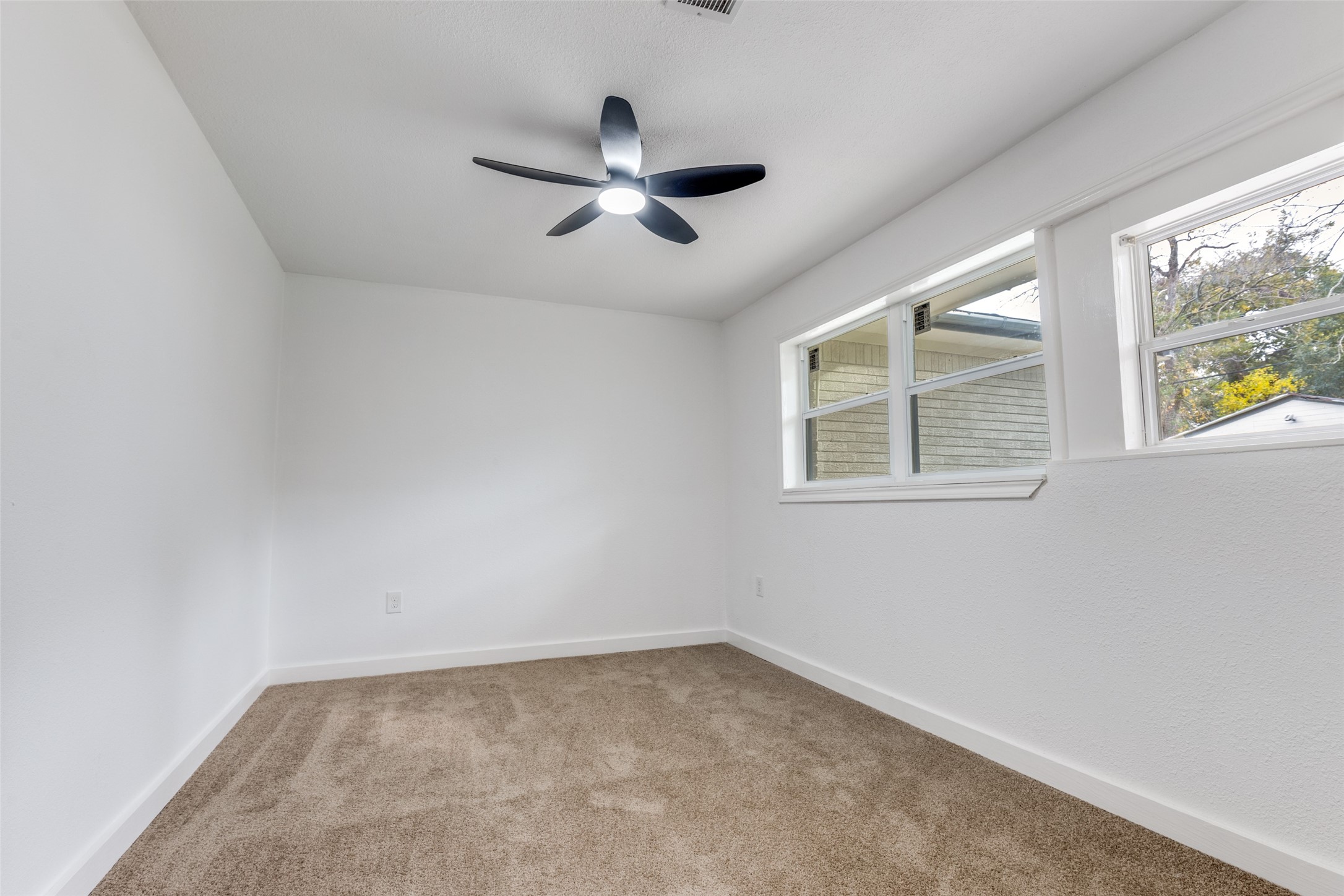 2545 Jackson La Marque, TX 77568 - Photo 22 of 30 an empty room with windows and fan