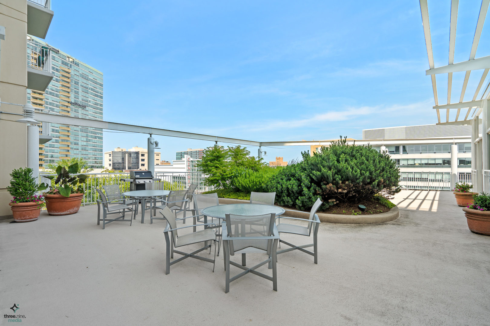 1640 Maple Avenue, Unit 1205 Evanston, IL 60201 - Photo 22 of 25 a view of a patio with dining table and chairs and potted plants
