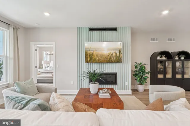 a living room with furniture fireplace and potted plant