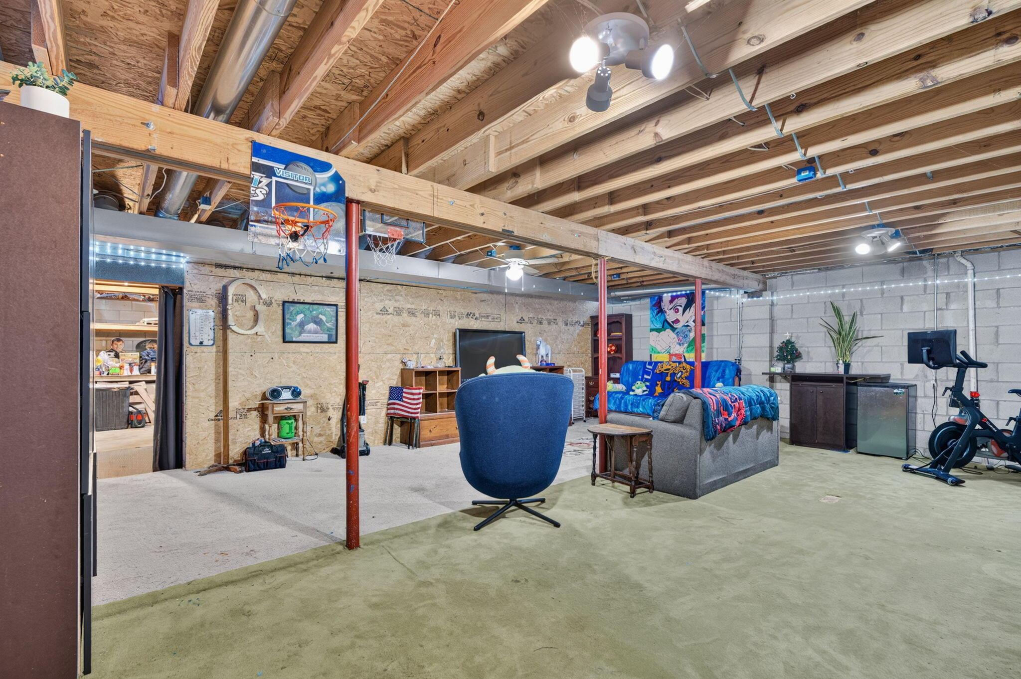 4780 North Section Line Road Radnor, OH 43066 - Photo 60 of 79 Spacious finished basement with exposed wood joist ceiling, concrete block walls, and recessed lighting
