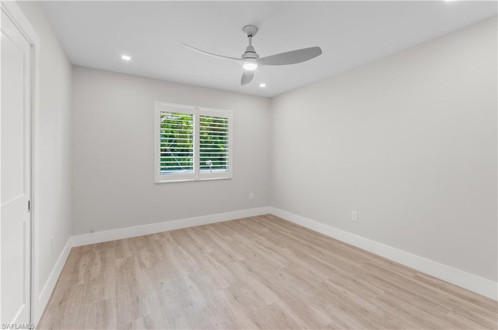 54 Liberty Lane Naples, FL 34112 - Photo 14 of 30 Empty room featuring light wood finished floors, a ceiling fan, and recessed lighting