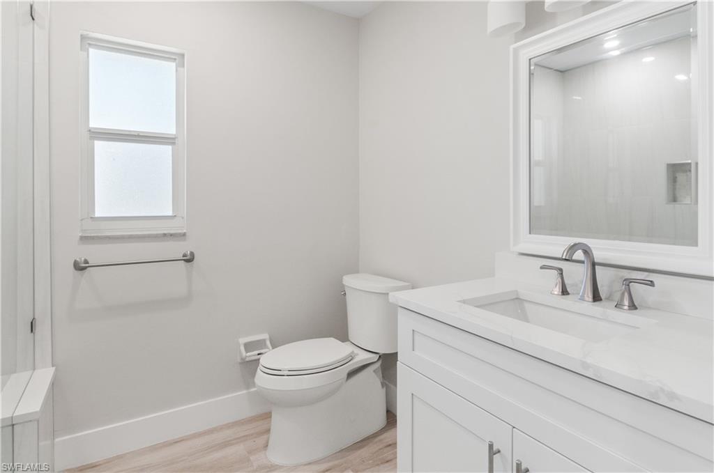 54 Liberty Lane Naples, FL 34112 - Photo 16 of 30 Bathroom #2 with vanity and light wood-style floors