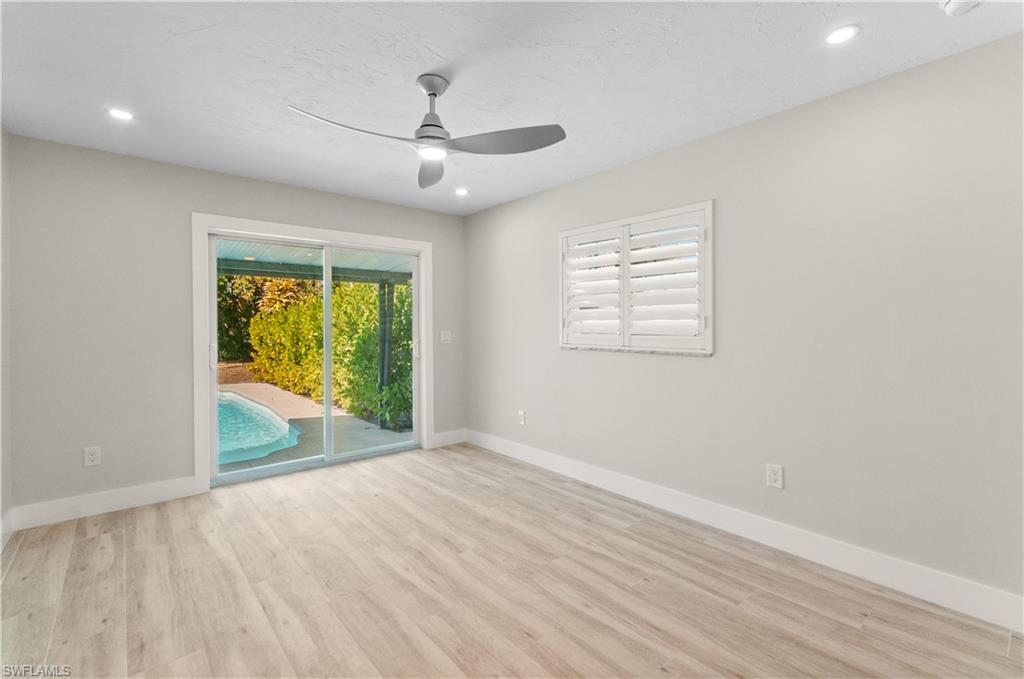 54 Liberty Lane Naples, FL 34112 - Photo 18 of 30 MAIN BEDROOM, SLIDERS TO POOL, ENSUITE BATHROOM