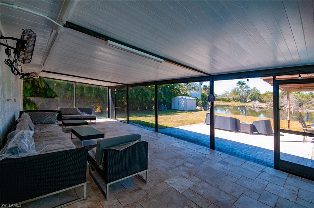 54 Liberty Lane Naples, FL 34112 - Photo 22 of 30 View of SCREENED PORCH with outdoor OVER SIZED PORCH SCREEND IN lounge area, VIEWS BACK YARD, LAKE,