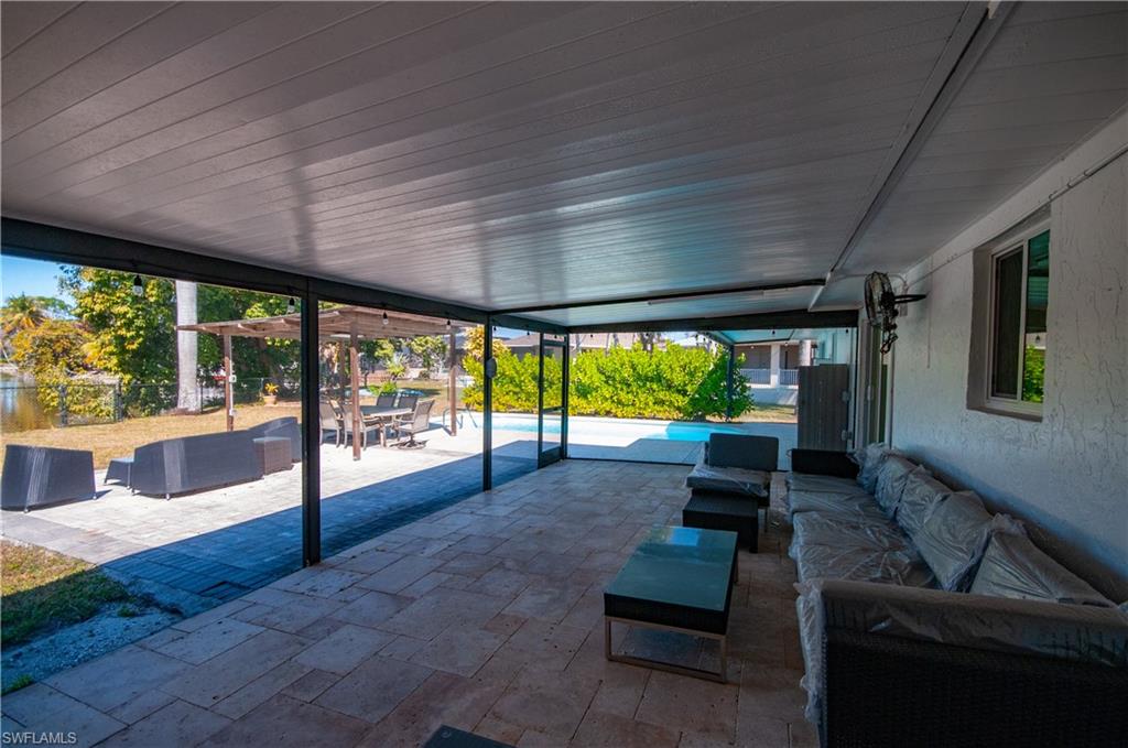 54 Liberty Lane Naples, FL 34112 - Photo 23 of 30 Fenced backyard with an outdoor living SCREENED space, a patio area, and an outdoor pool