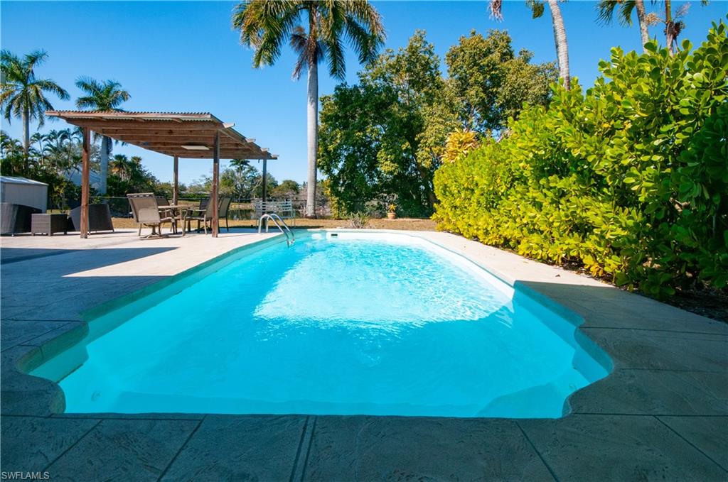 54 Liberty Lane Naples, FL 34112 - Photo 26 of 30 Outdoor pool featuring a patio salt water pool