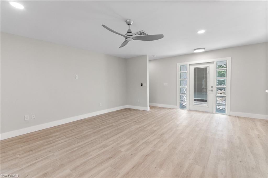 54 Liberty Lane Naples, FL 34112 - Photo 8 of 30 Unfurnished room featuring a ceiling fan, light wood finished floors, and recessed lighting