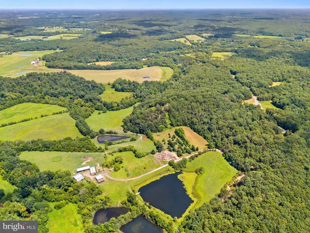 an aerial view of ocean with residential house and outdoor space