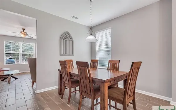 a view of a dining room with furniture and window